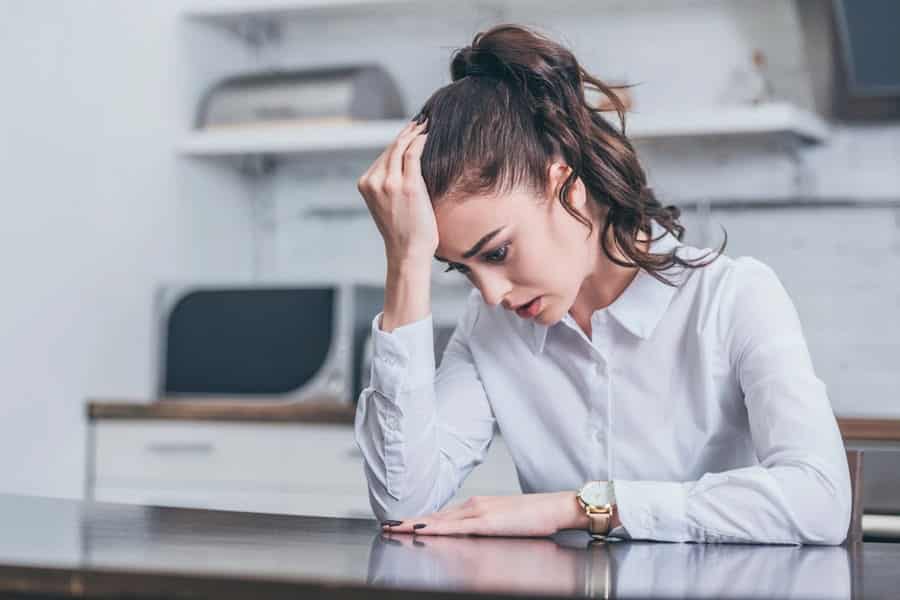 I want to change, but how? Frustrated woman with head in hand. I want to change, but how?