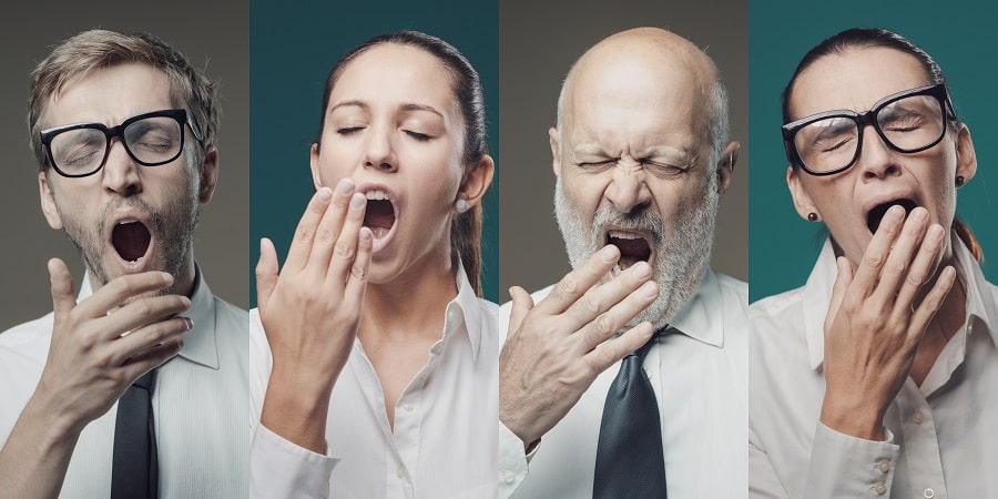 Four individuals yawning, symbolizing how Bible reading can feel boring without fresh perspective